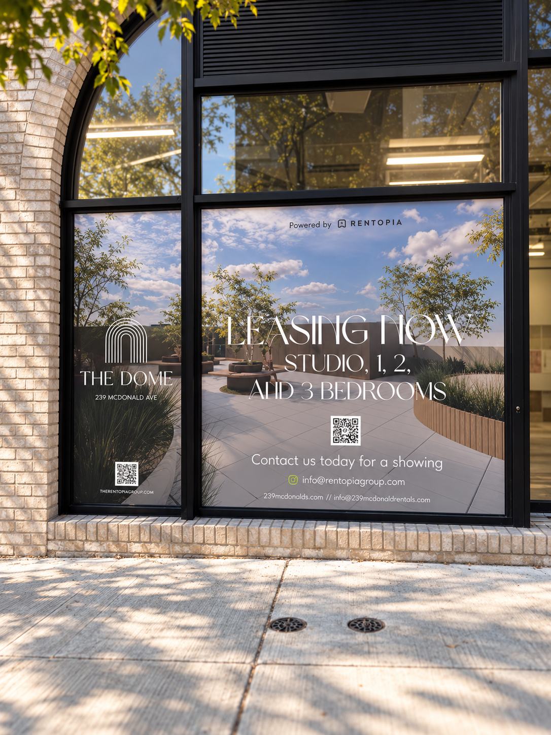 The Dome leasing window at 239 McDonald Ave, Brooklyn, with the arched building logo and Leasing Now, Studio, 1, 2 and 3 bedrooms, a QR code and showing contact details. Window graphics by Studio Heym.